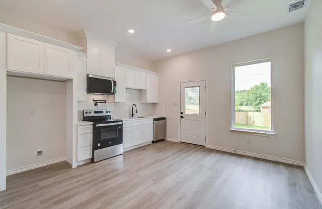 a view of a hallway with wooden floor