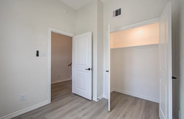 a view of kitchen with wooden floor and electronic appliances