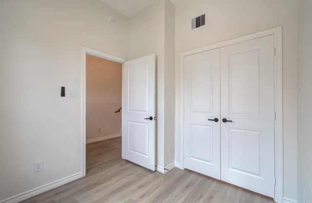 a view of kitchen with wooden floor and electronic appliances