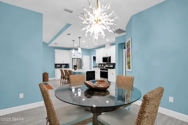 a dining room with furniture and chandelier