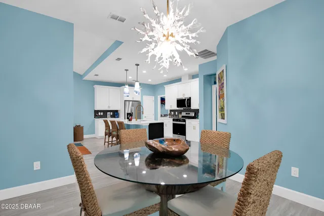 a dining room with furniture and chandelier