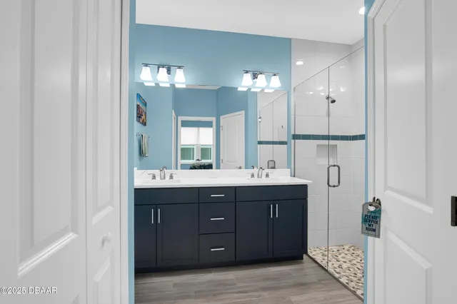 a bathroom with a double vanity sink and mirror