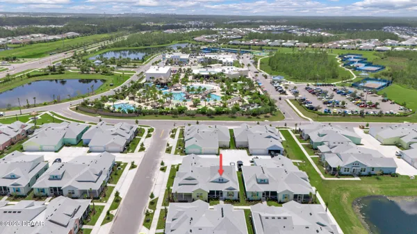 an aerial view of residential houses with outdoor space and river