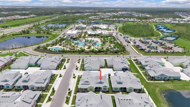 an aerial view of residential houses with outdoor space and river