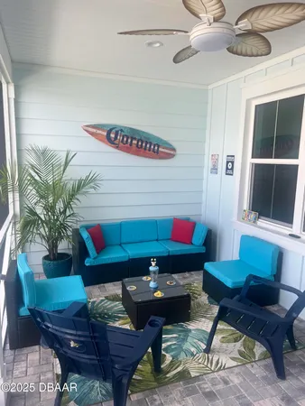 a living room with furniture and a potted plant
