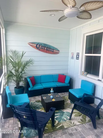 a living room with furniture and a potted plant