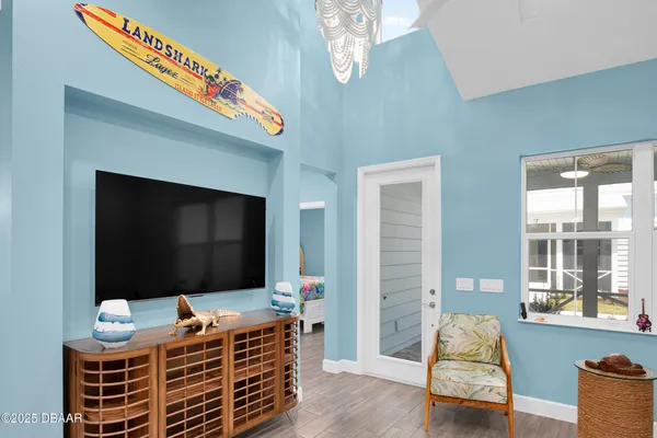 a room with wooden floor and windows