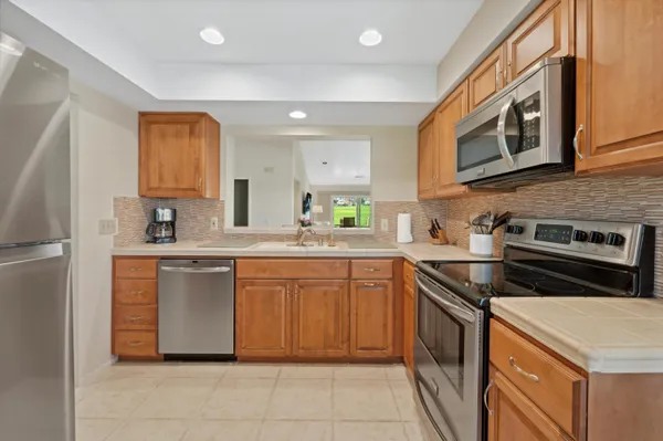 a kitchen with stainless steel appliances granite countertop a stove sink and cabinets