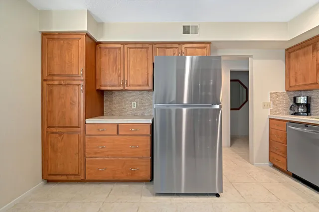 a kitchen with stainless steel appliances granite countertop a refrigerator and a sink