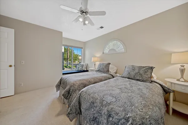 a bedroom with two beds and a window