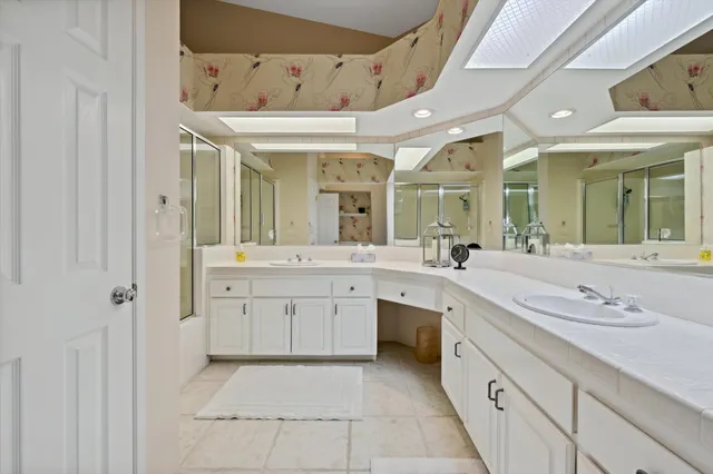 a spacious bathroom with a granite countertop sink mirror and