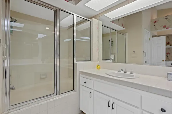 a bathroom with a granite countertop sink mirror and double