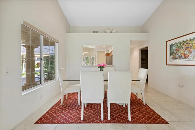 a view of a dining room with furniture and a window