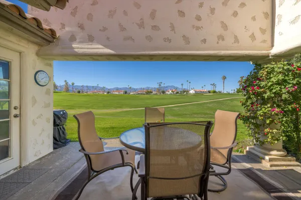 a view of a chair and table in the backyard