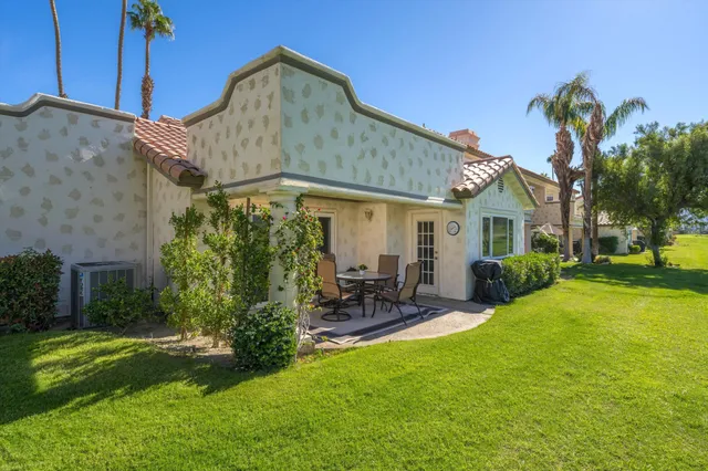 a front view of house with yard and outdoor seating