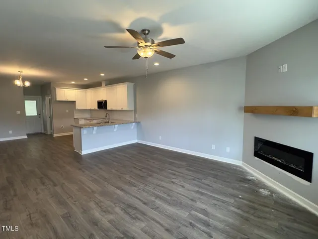 a view of a kitchen with a sink cabinets and a fireplace