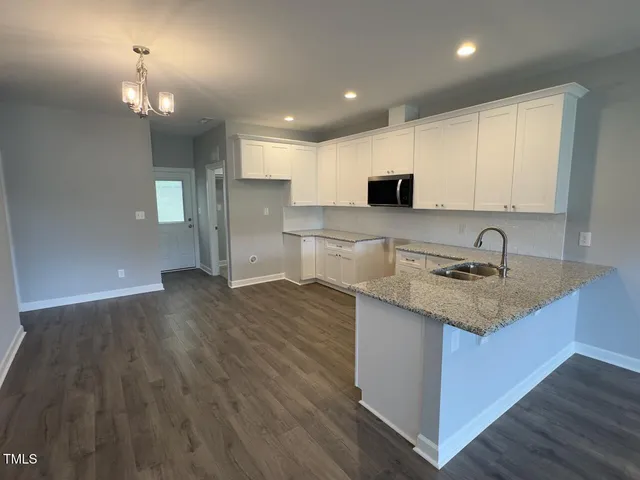 a kitchen with a sink and a stove top oven