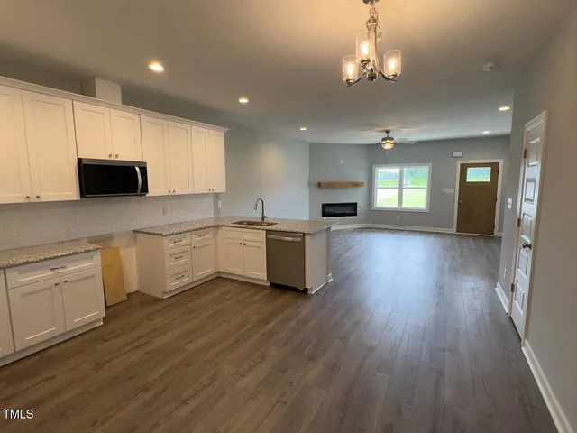 a kitchen with a white cabinets sink and stainless steel appliances
