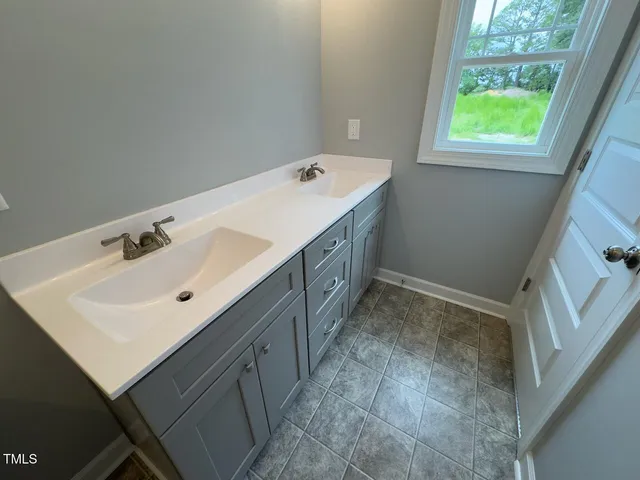 a bathroom with a sink and a window