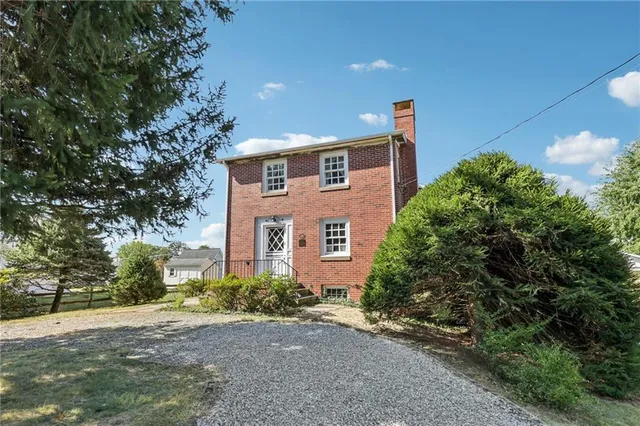a front view of a house with a yard and a garage