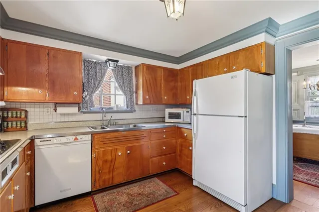 a kitchen with a refrigerator a sink and cabinets