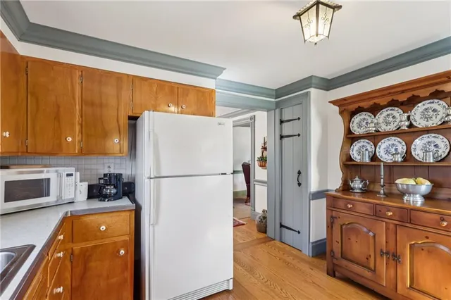 a white refrigerator freezer sitting inside of a kitchen