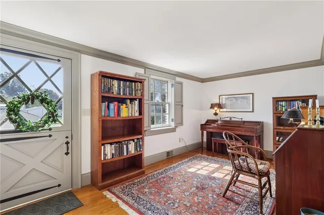 a view of a workspace with furniture and window