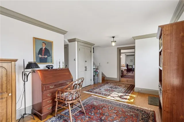 a living room with furniture a dining table and chairs with wooden floor