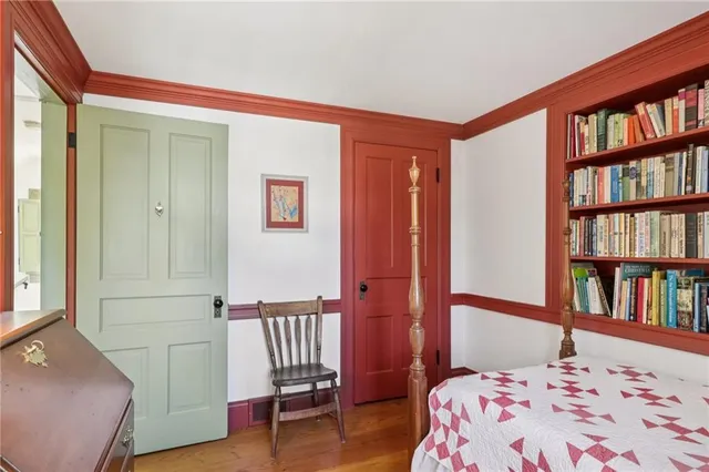 a bedroom with a bed and a book shelf