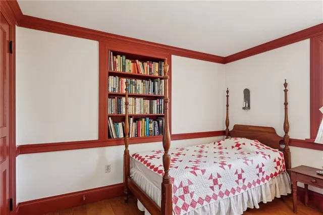 a bedroom with a bed and a book shelf