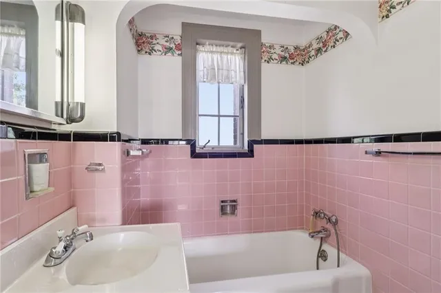 a bath room with a bathtub and a sink