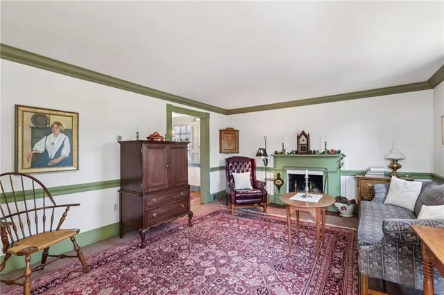 a living room with furniture a rug and a fireplace