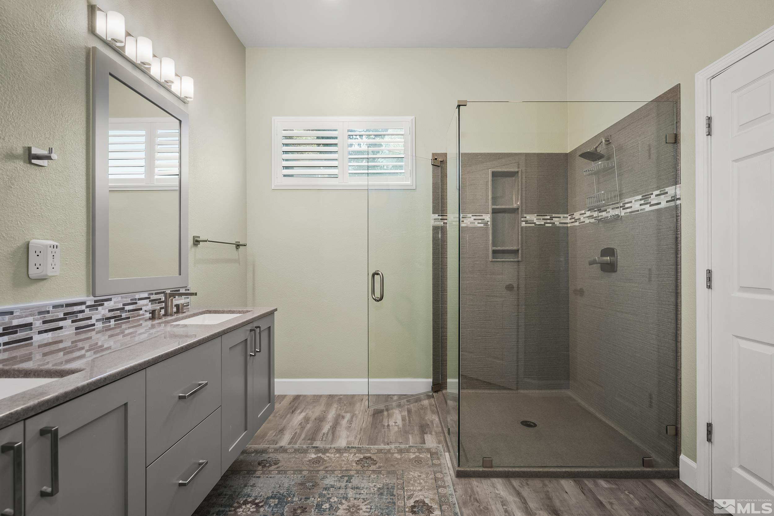 10245 Grizzly Hill Court Reno, NV 89521 - Photo 16 of 40 a bathroom with a shower sink and mirror