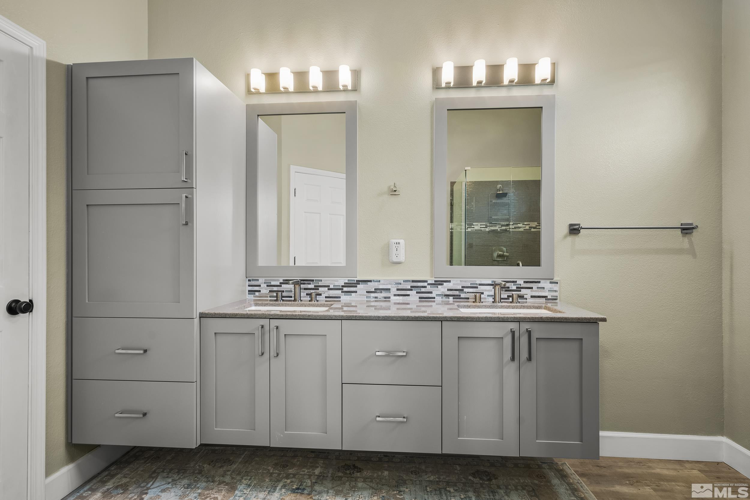 10245 Grizzly Hill Court Reno, NV 89521 - Photo 17 of 40 a bathroom with a granite countertop sink and a mirror