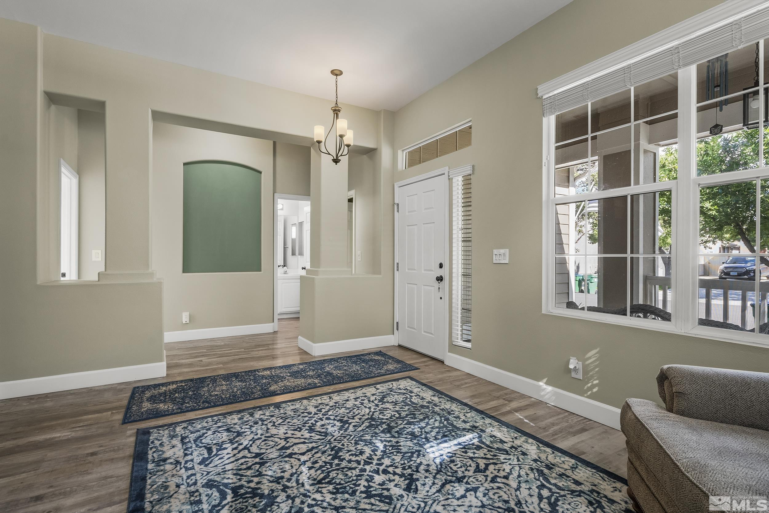 10245 Grizzly Hill Court Reno, NV 89521 - Photo 23 of 40 a view of a hallway with wooden floor and windows