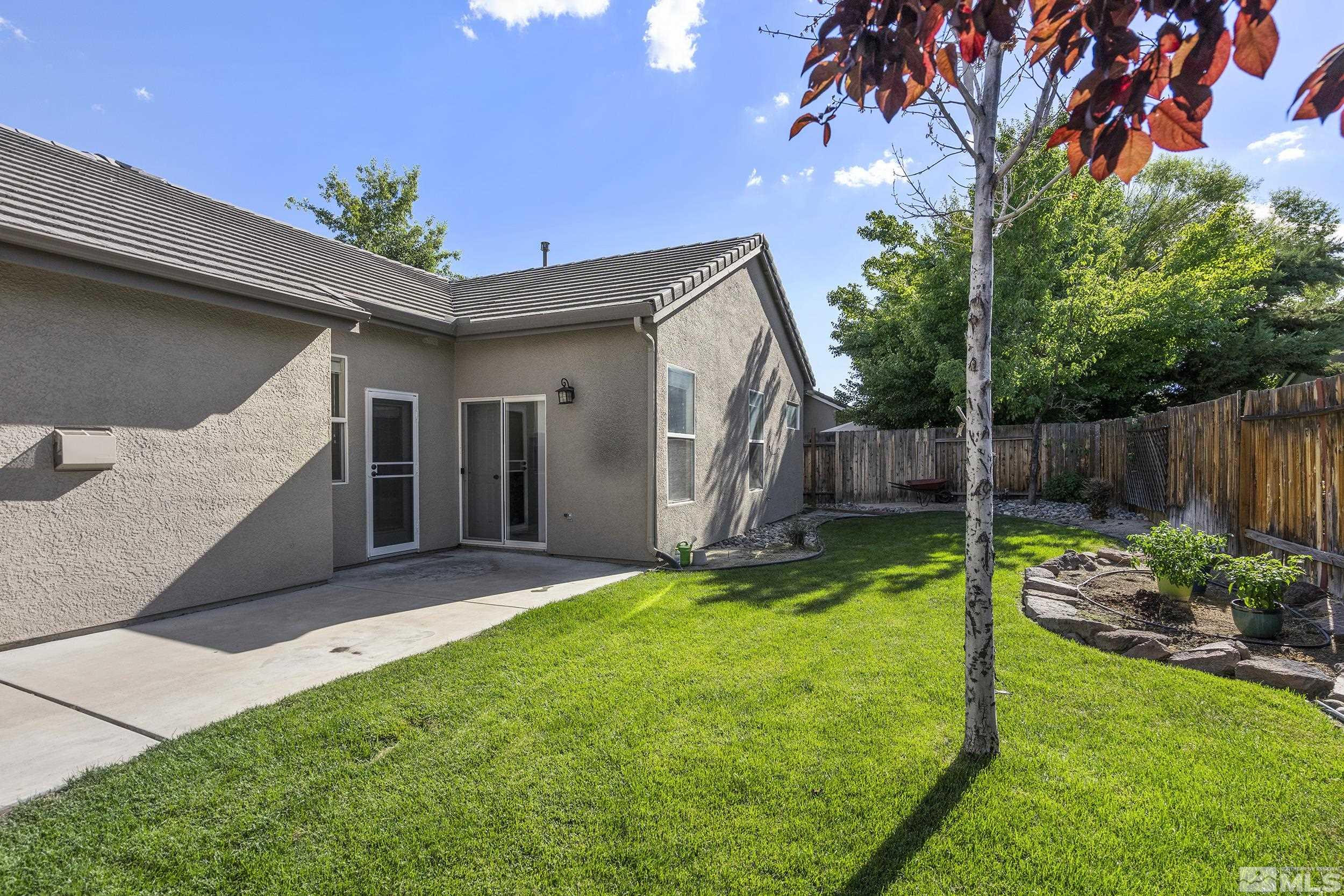 10245 Grizzly Hill Court Reno, NV 89521 - Photo 30 of 40 a backyard of a house with table and chairs