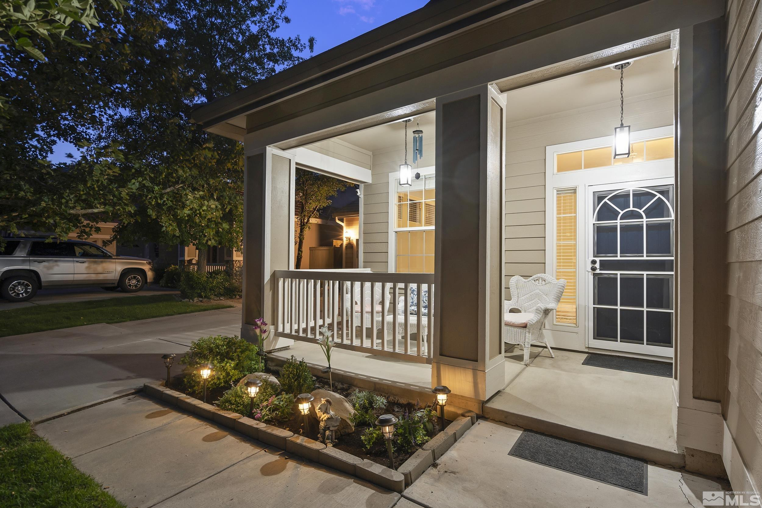 10245 Grizzly Hill Court Reno, NV 89521 - Photo 3 of 40 a front view of a house with a garden