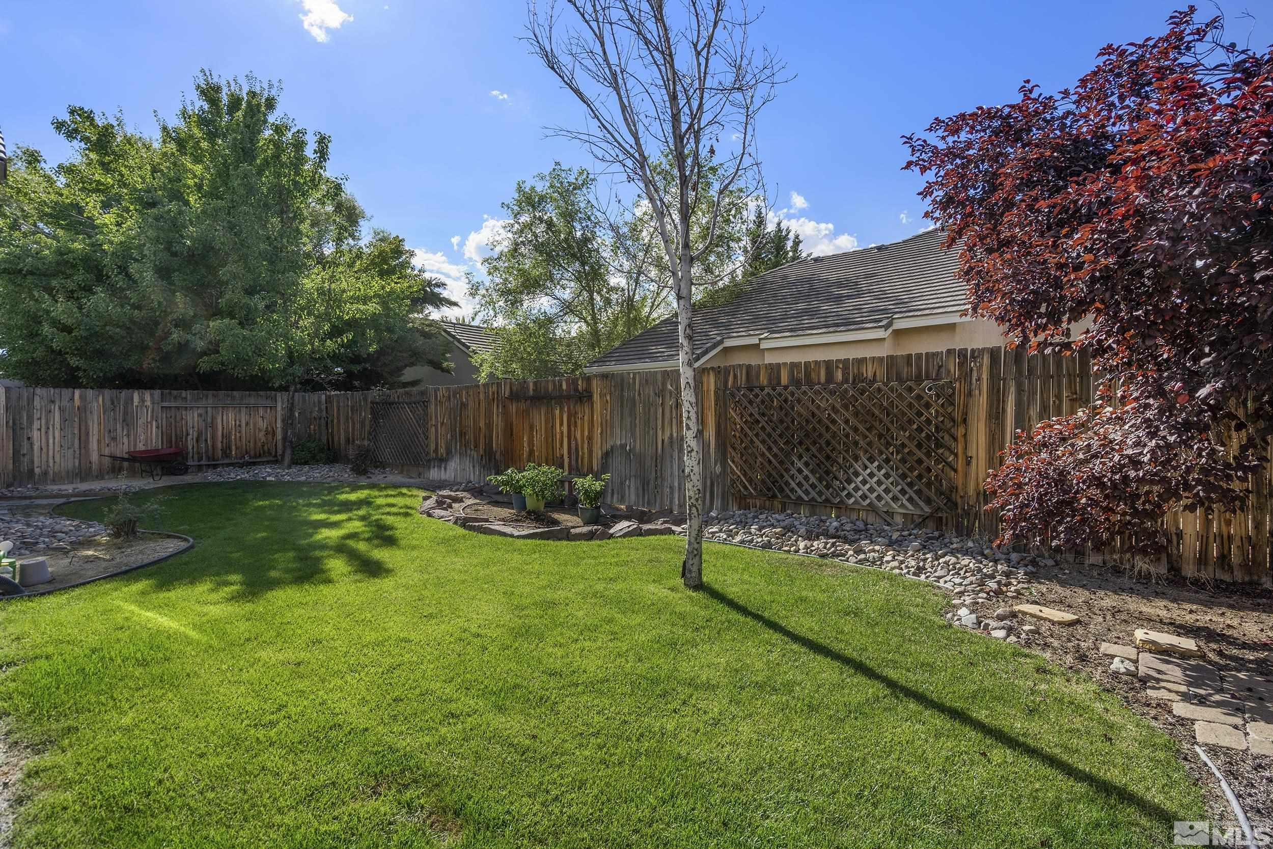 10245 Grizzly Hill Court Reno, NV 89521 - Photo 33 of 40 a view of a backyard with a garden and slide