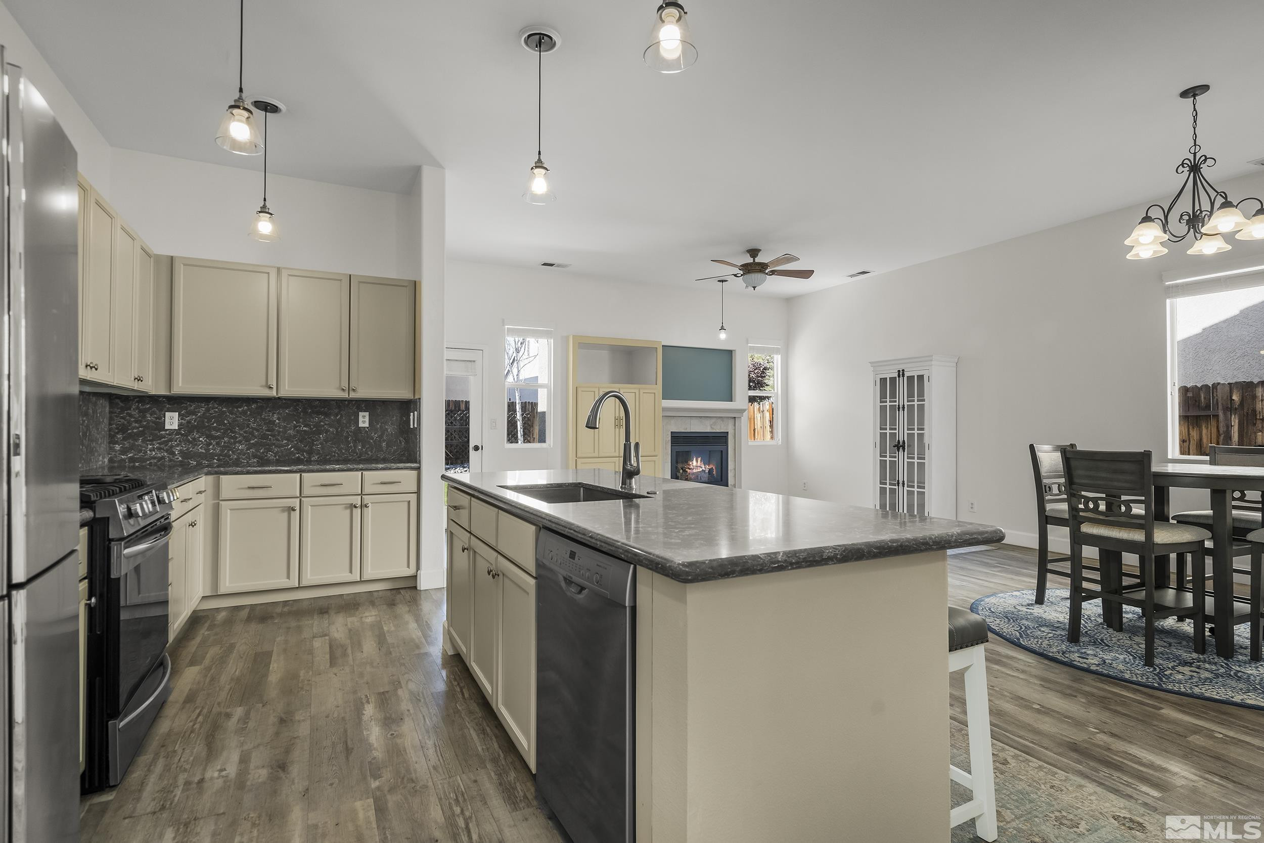 10245 Grizzly Hill Court Reno, NV 89521 - Photo 8 of 40 a kitchen with stainless steel appliances granite countertop a sink stove and refrigerator