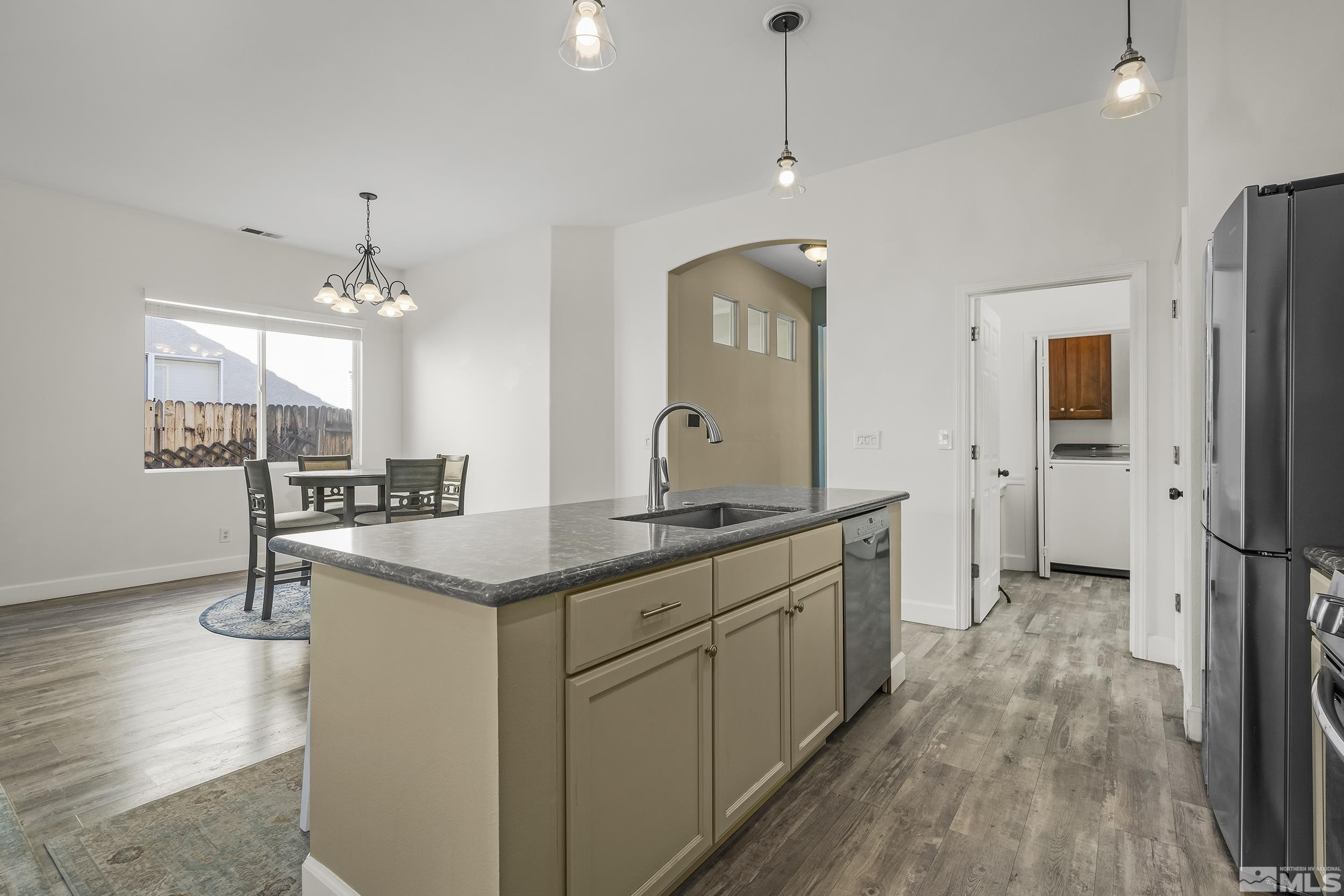 10245 Grizzly Hill Court Reno, NV 89521 - Photo 9 of 40 a kitchen with stainless steel appliances granite countertop a sink refrigerator and microwave