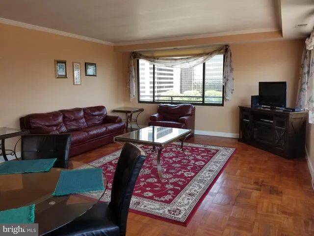 a living room with furniture rug and a window