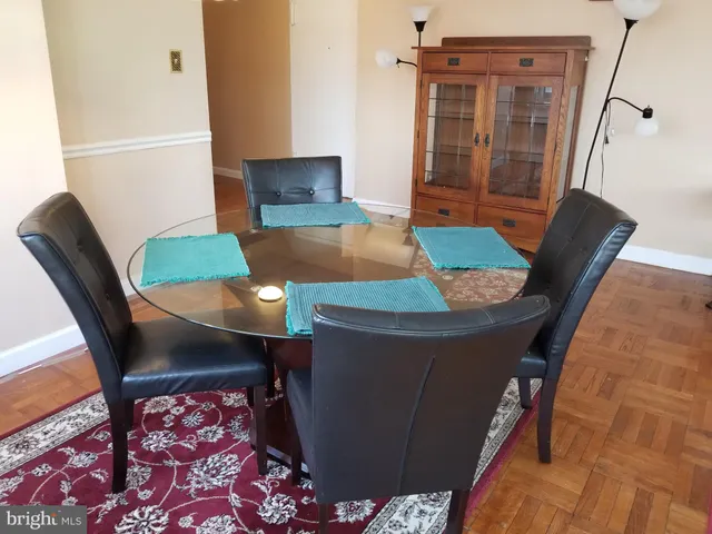 a view of a dining room with furniture and wooden floor