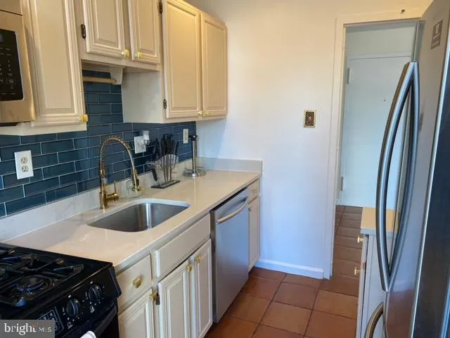 a kitchen with a sink and a refrigerator