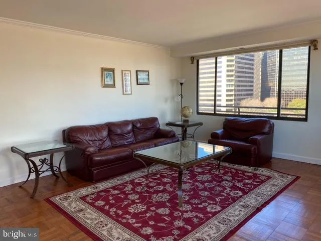 a living room with furniture a rug and a large window