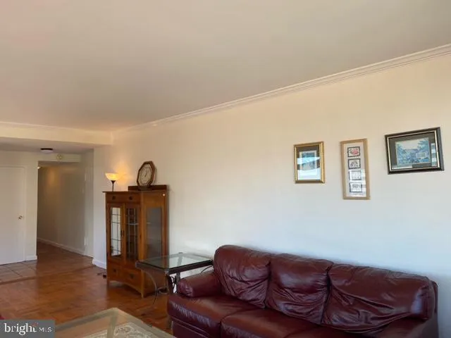 a living room with furniture a flat screen tv and a couch