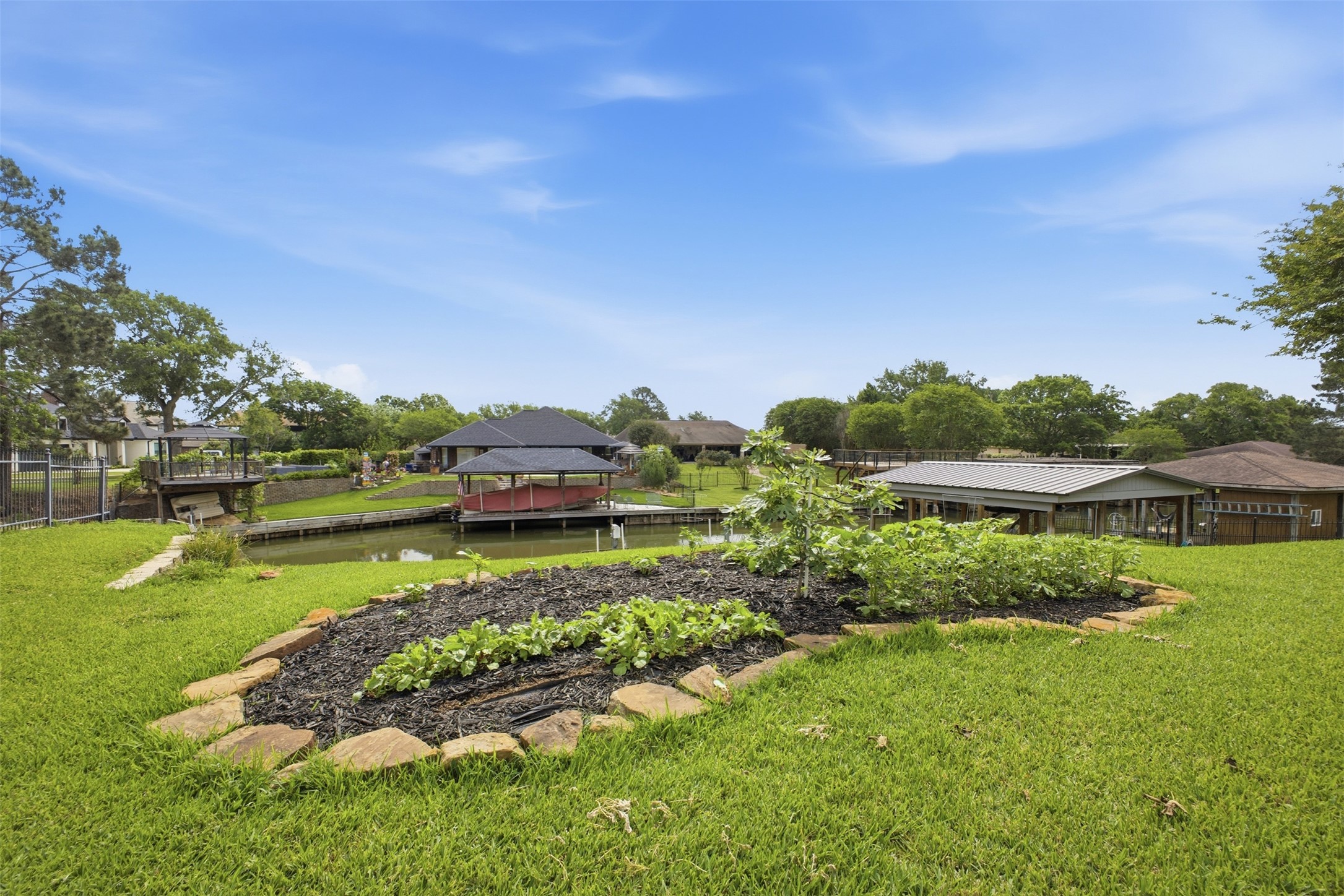 12710 Aries Loop Willis, TX 77318 - Photo 37 of 40 The property features a well-maintained lawn with a landscaped garden bed, including various plants and trees