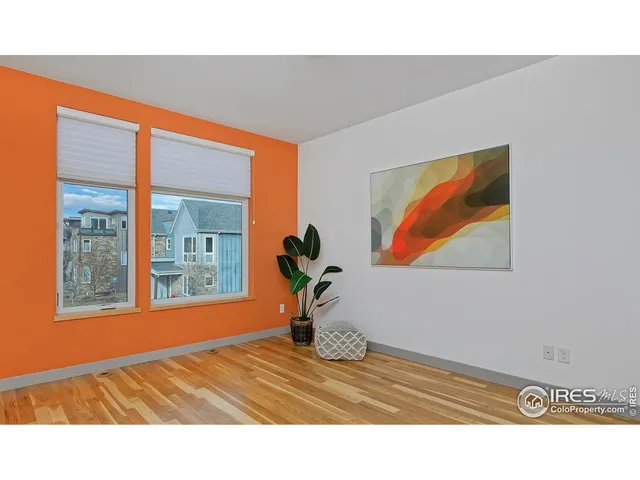 a view of an empty room and wooden floor