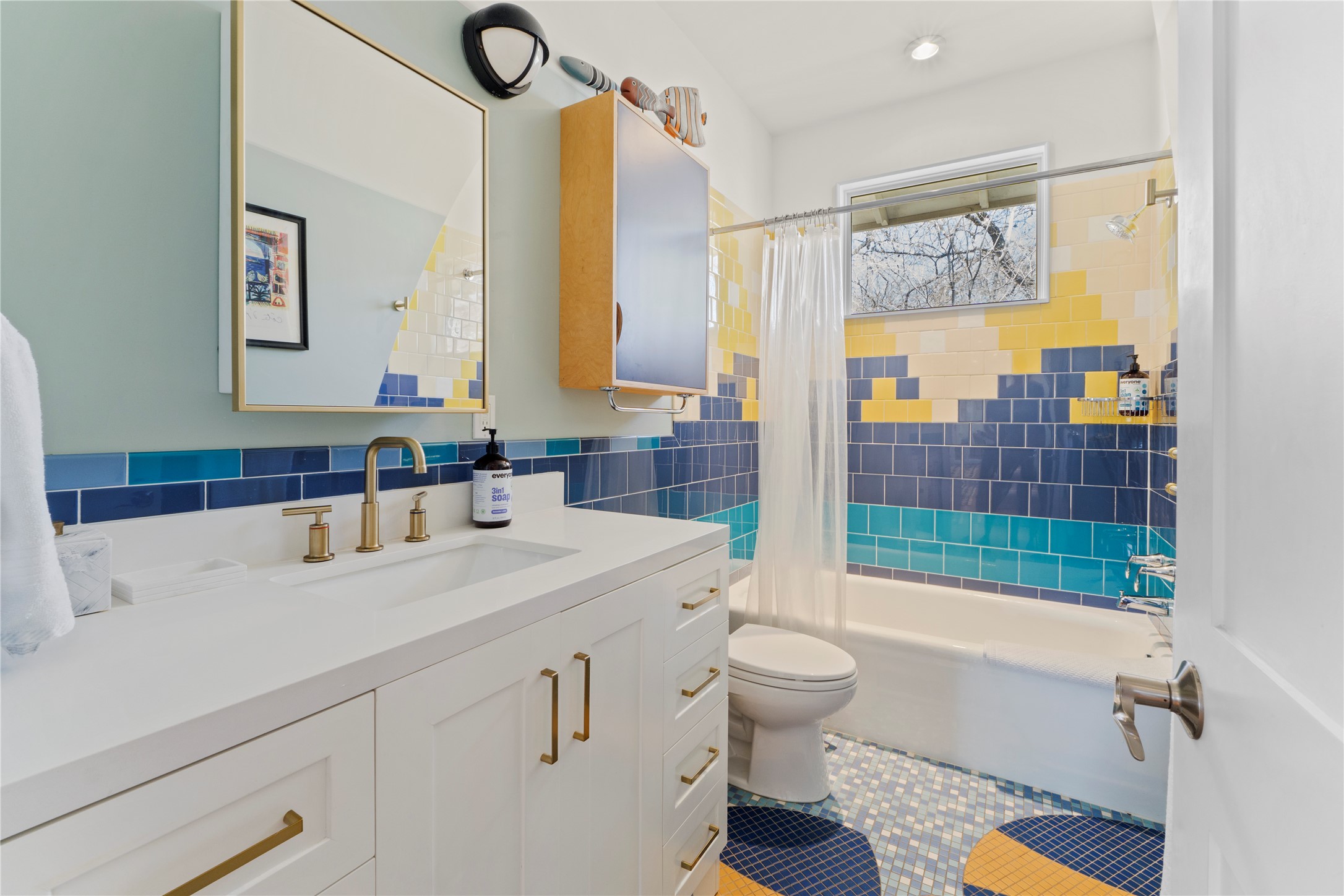 1706 West 10th Street Austin, TX 78703 - Photo 23 of 31 a bathroom with a sink a toilet a mirror and shower