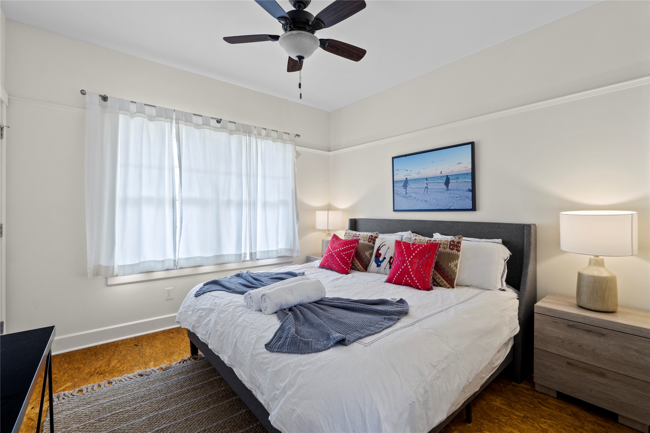 1706 West 10th Street Austin, TX 78703 - Photo 26 of 31 a bedroom with a large bed and a chandelier