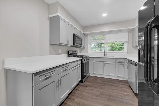 a kitchen with a sink stove and refrigerator